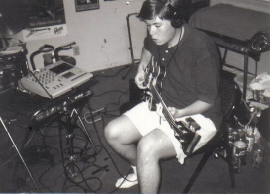 Early '90's picture of John recording demos on the Tascam 424 PortaStudio with his Eko Bass.